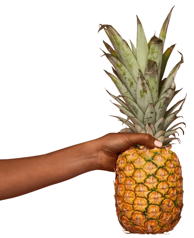 DOE Donuts a hand holding a whole pineapple