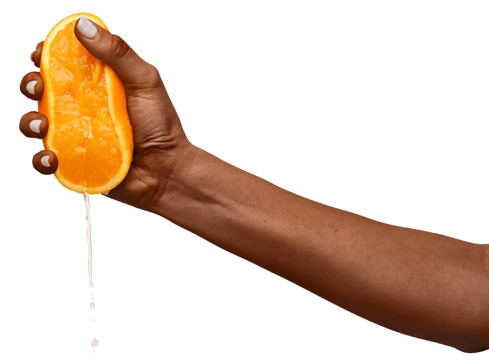 DOE Donuts - a hand squeezing a fresh orange